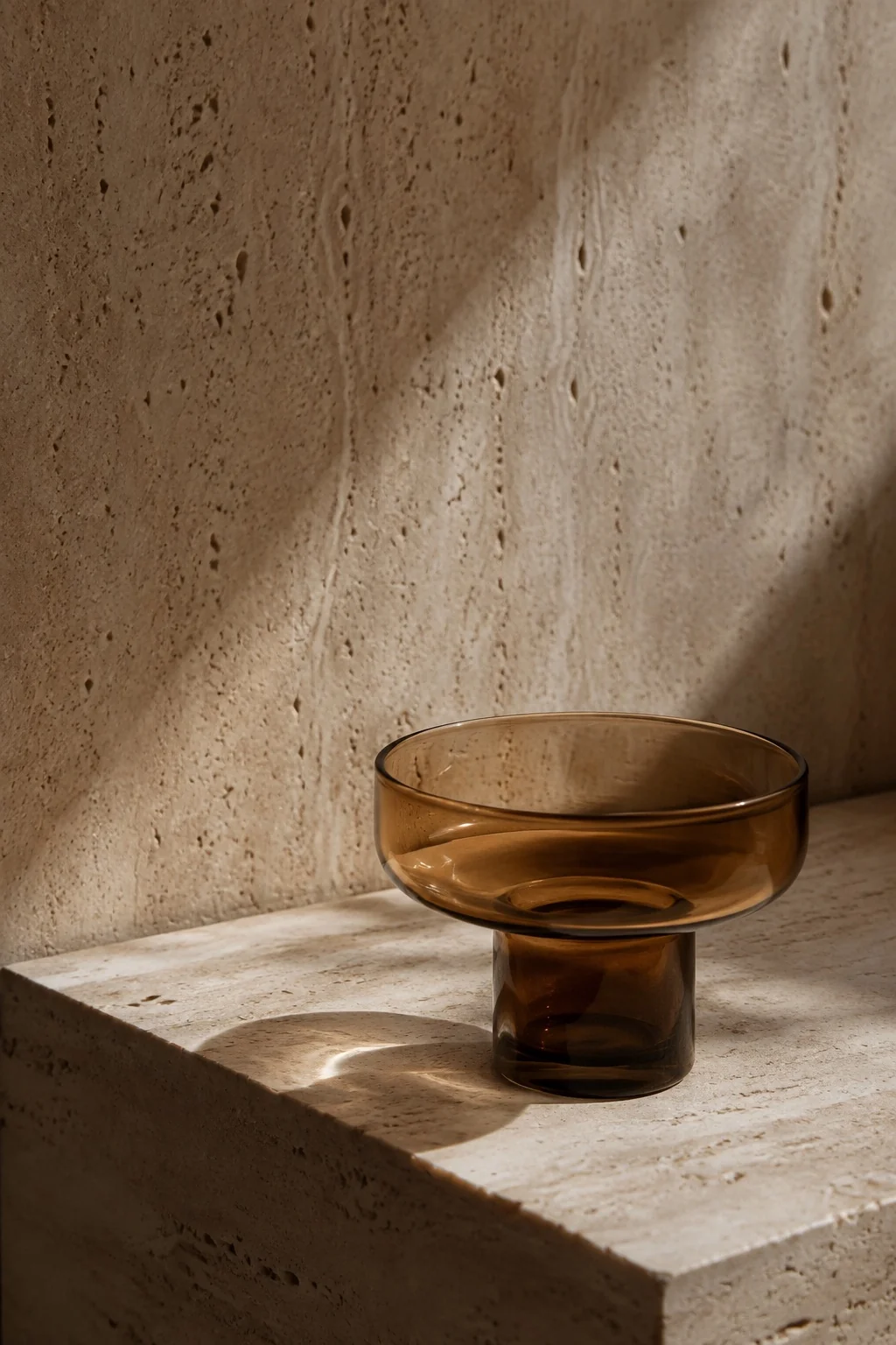 Amber glass on travertine; illustrative image, not a patient result.